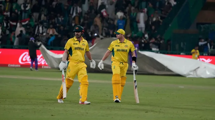 Australia secures knockout berth in Champions Trophy 2025 following rainout against Afghanistan.